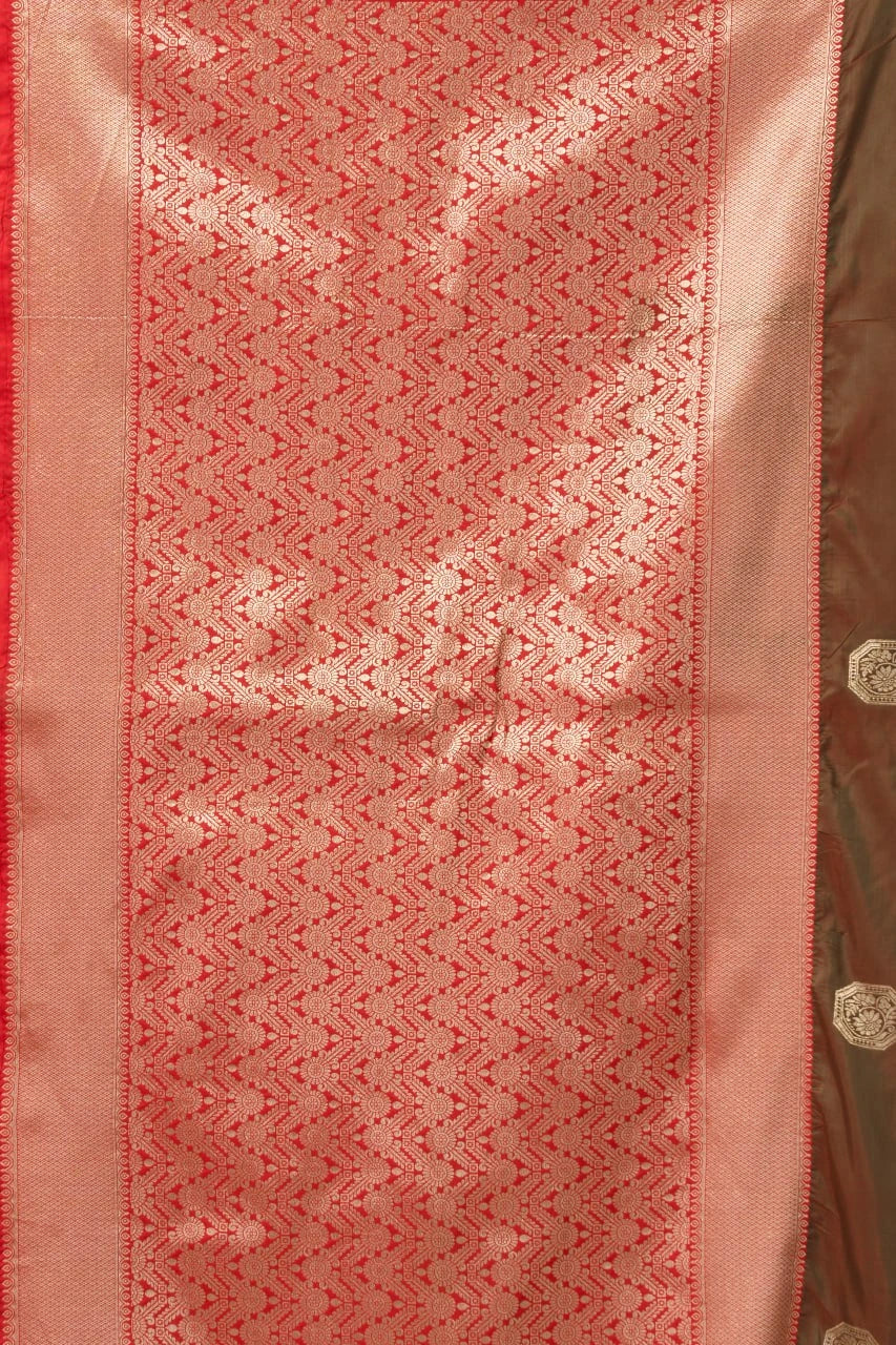 Close-up of a pink fabric with intricate patterns and a gold border.